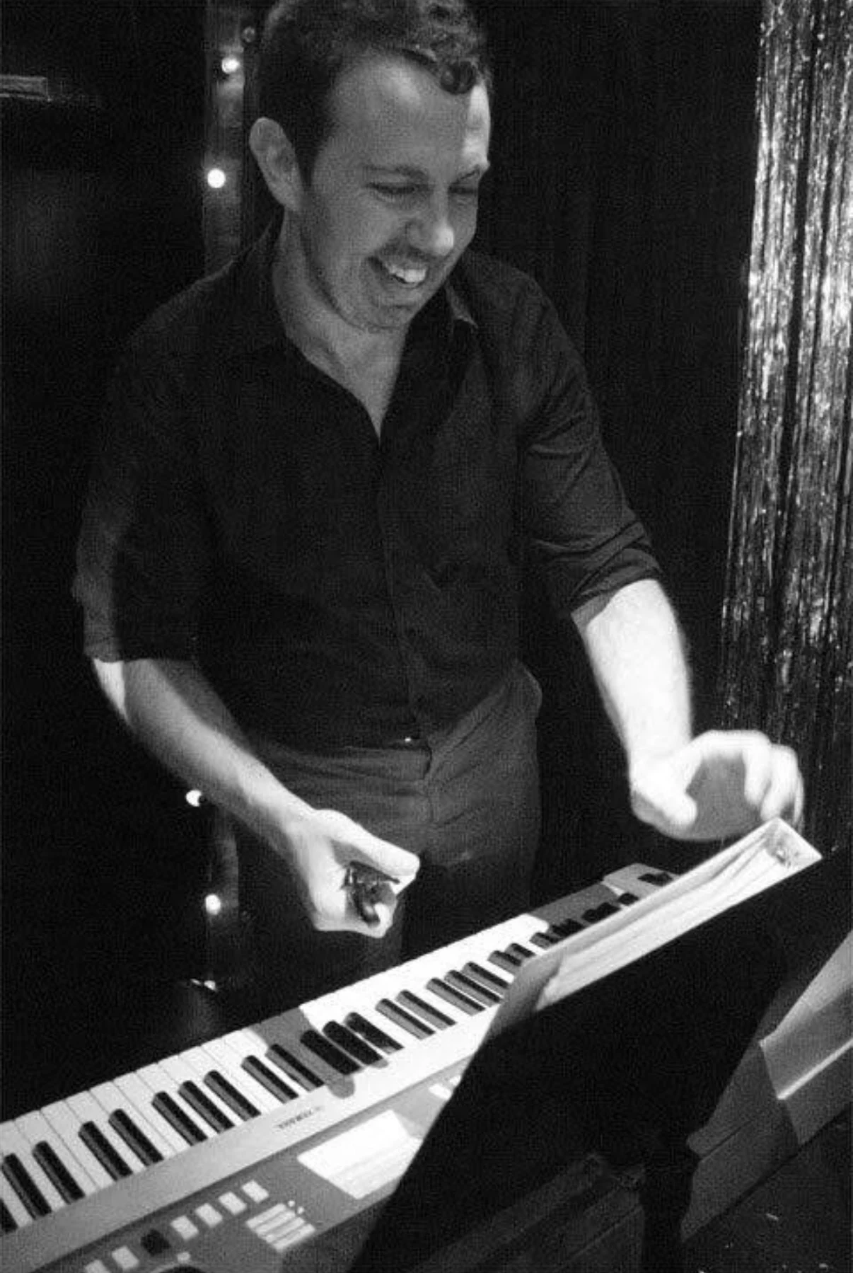 Daniel playing piano at a live performance